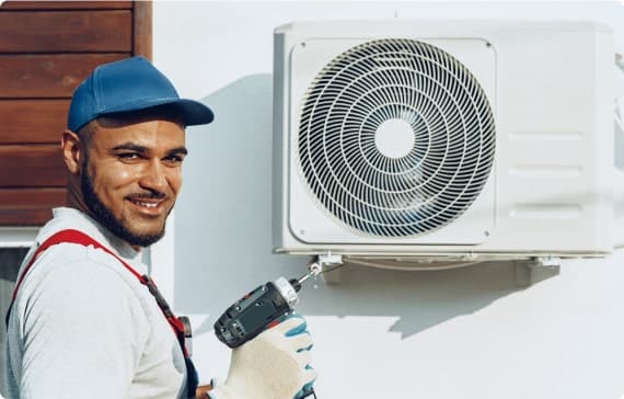 HVAC technician servicing an outdoor air conditioner