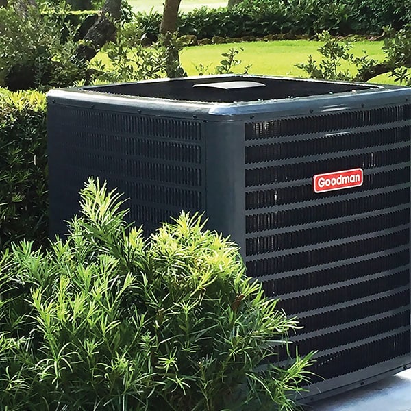 New central air conditioner condenser installed outside a home